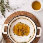 baked brie wheel in a dutch pot with thyme and honey.