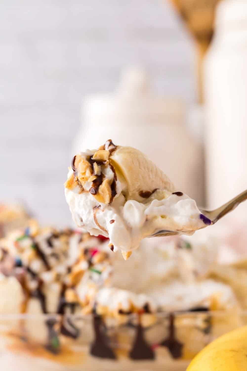 bite of banana split on a golden spoon.