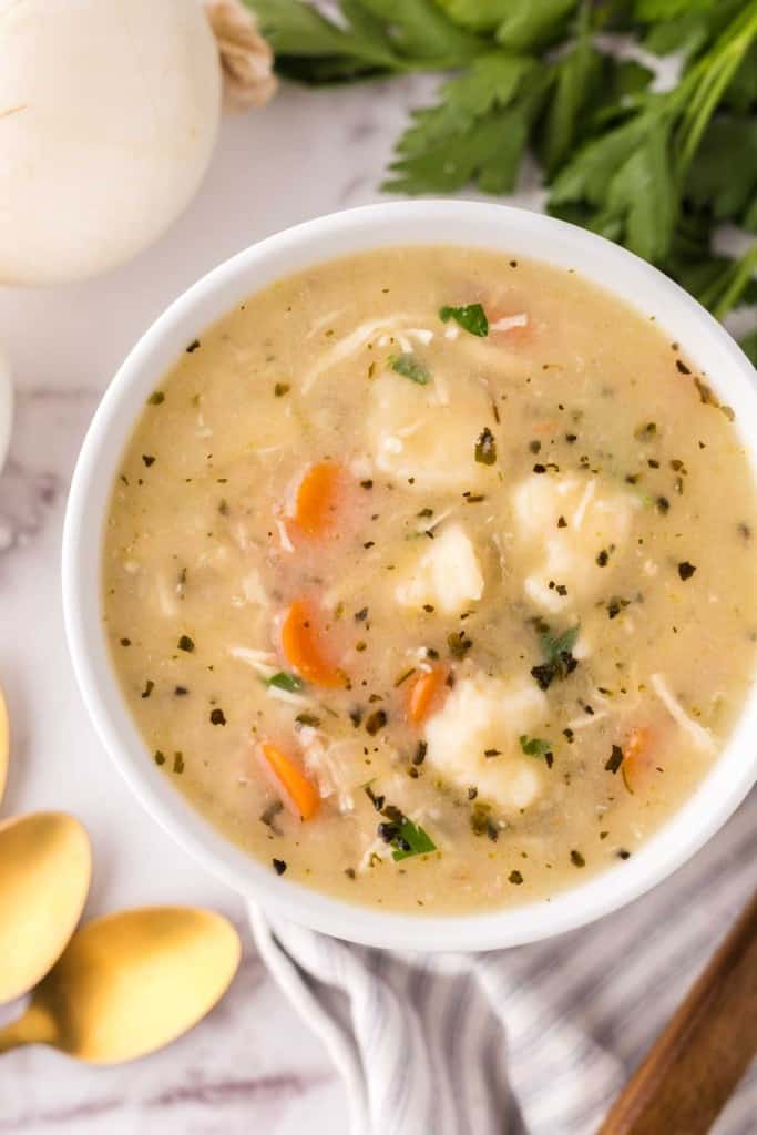 bisquick dumplings recipe in a white bowl with golden spoons.
