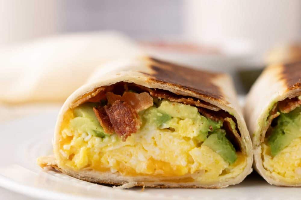 grilled breakfast burrito cut in half.