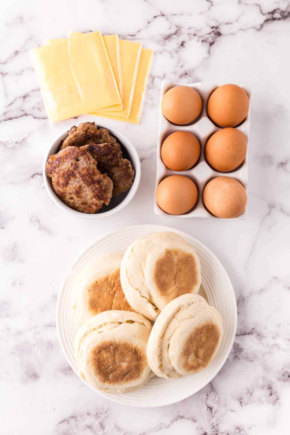 portion bowls each with raw ingredient to make the breakfast sandwich recipe.