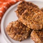 round plate with a stack of homemade breakfast sausage.