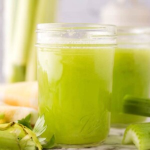 small mason jars with green celery juice.