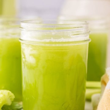 small mason jars with green celery juice.