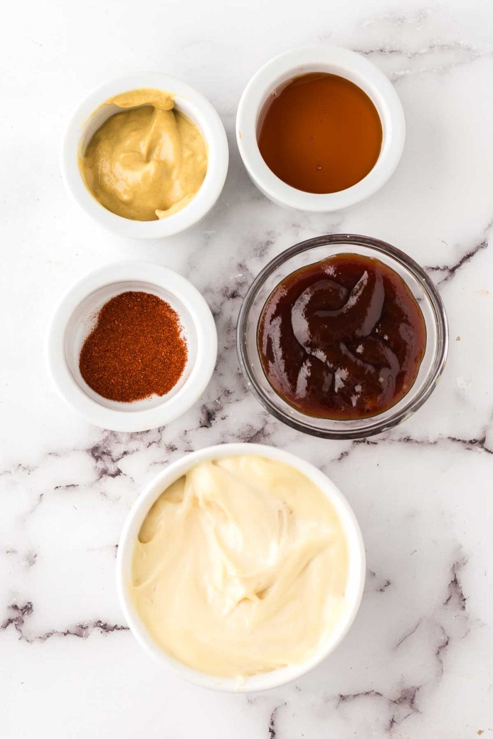 portion bowls each with raw ingredient to make Chick-fil-A Sauce.