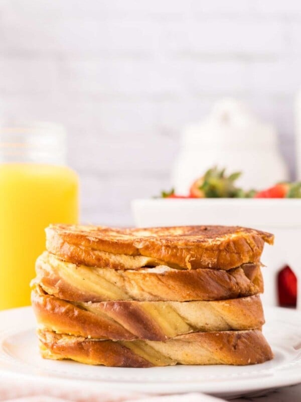 stack of four pieces of challah french toast bread on a plate.