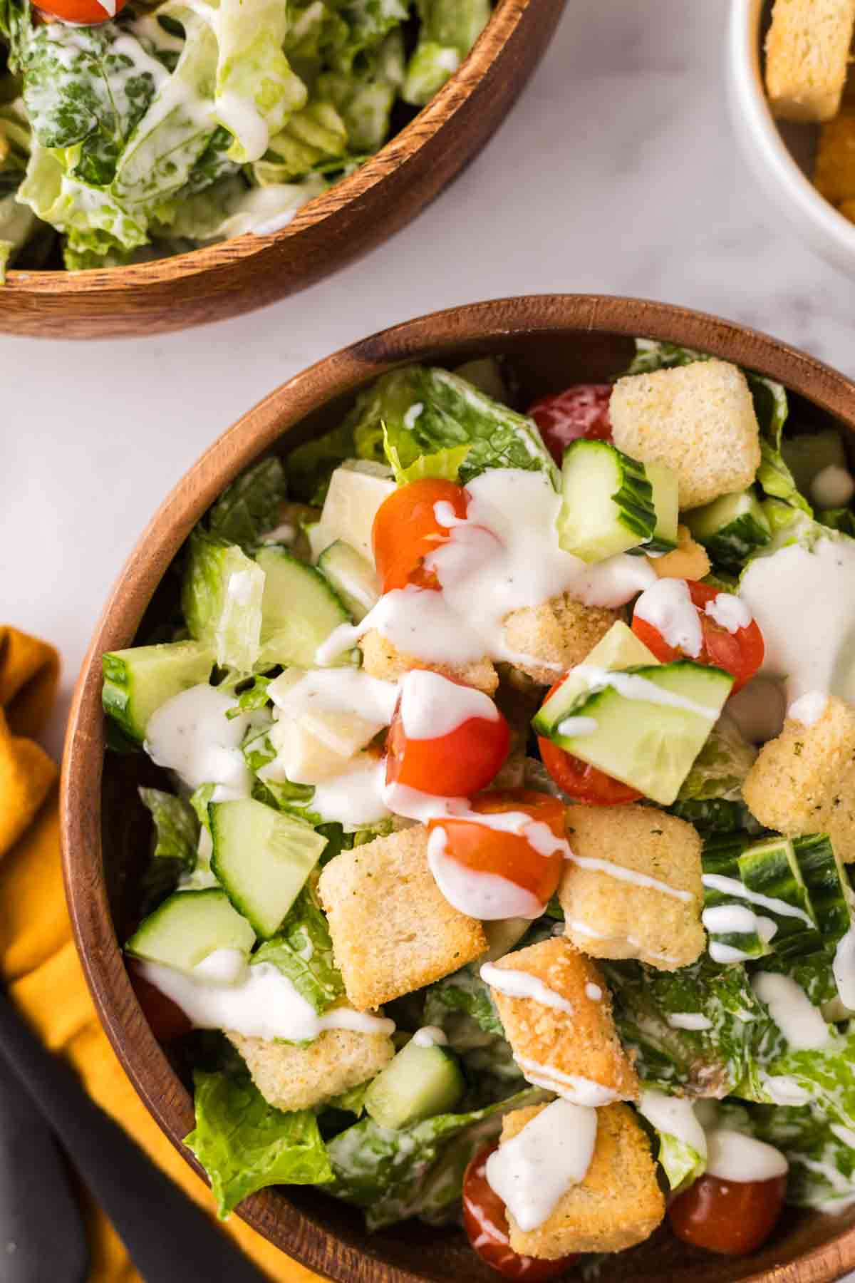 chef's salad in round wooden bowls.