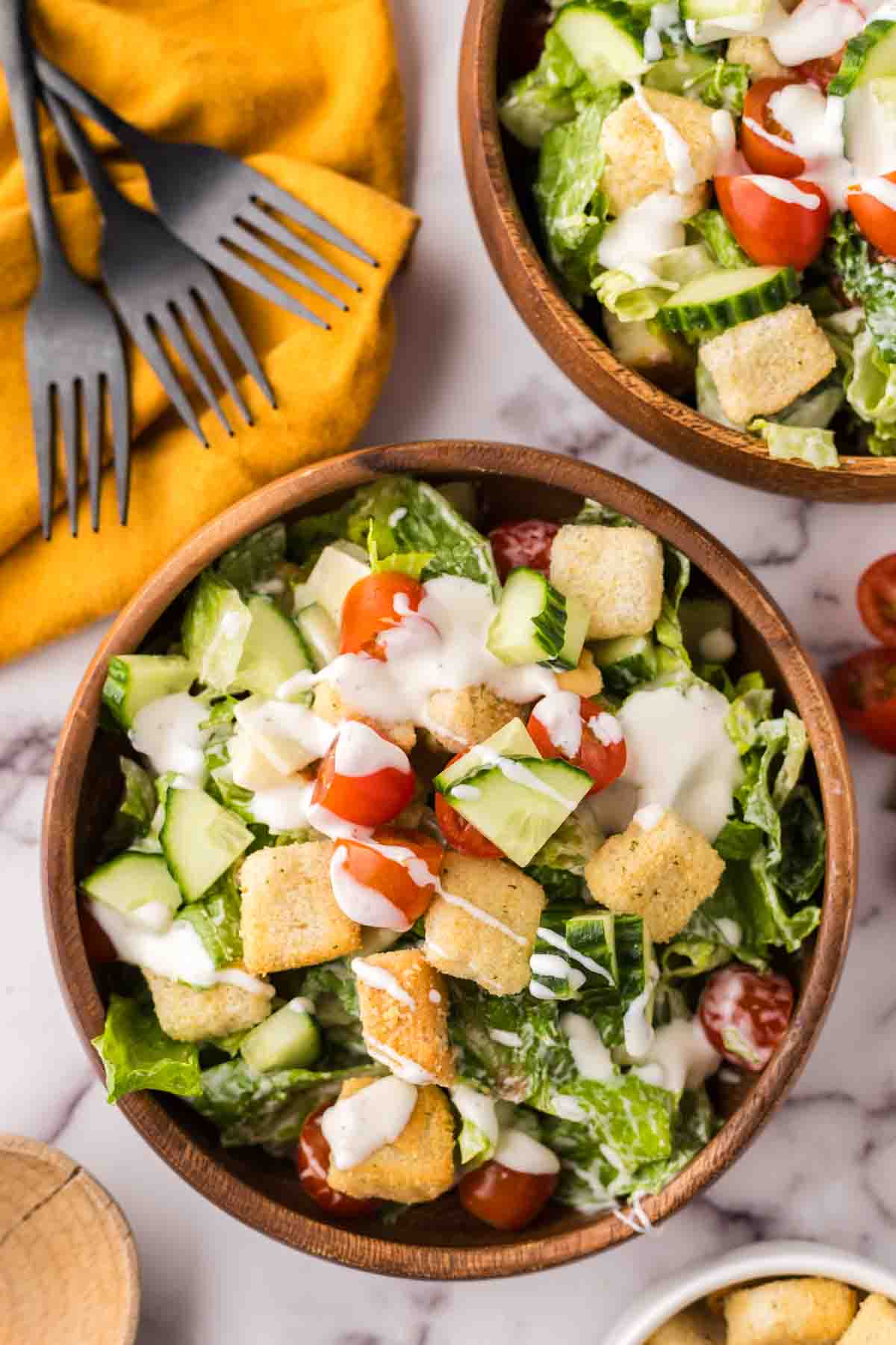 chef's salad in round wooden bowls.