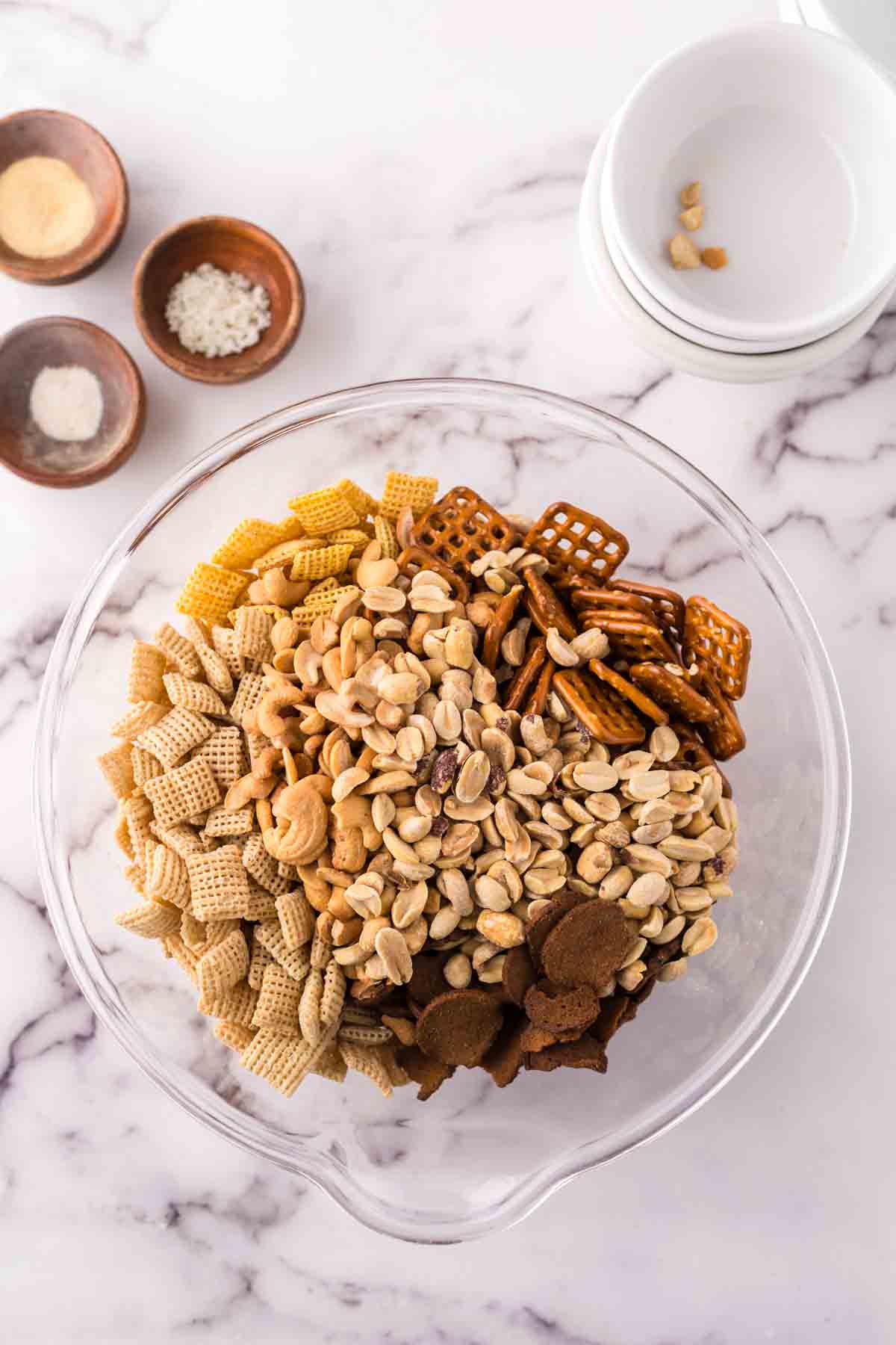 clear mixing bowl the progress of making chex mix recipe.