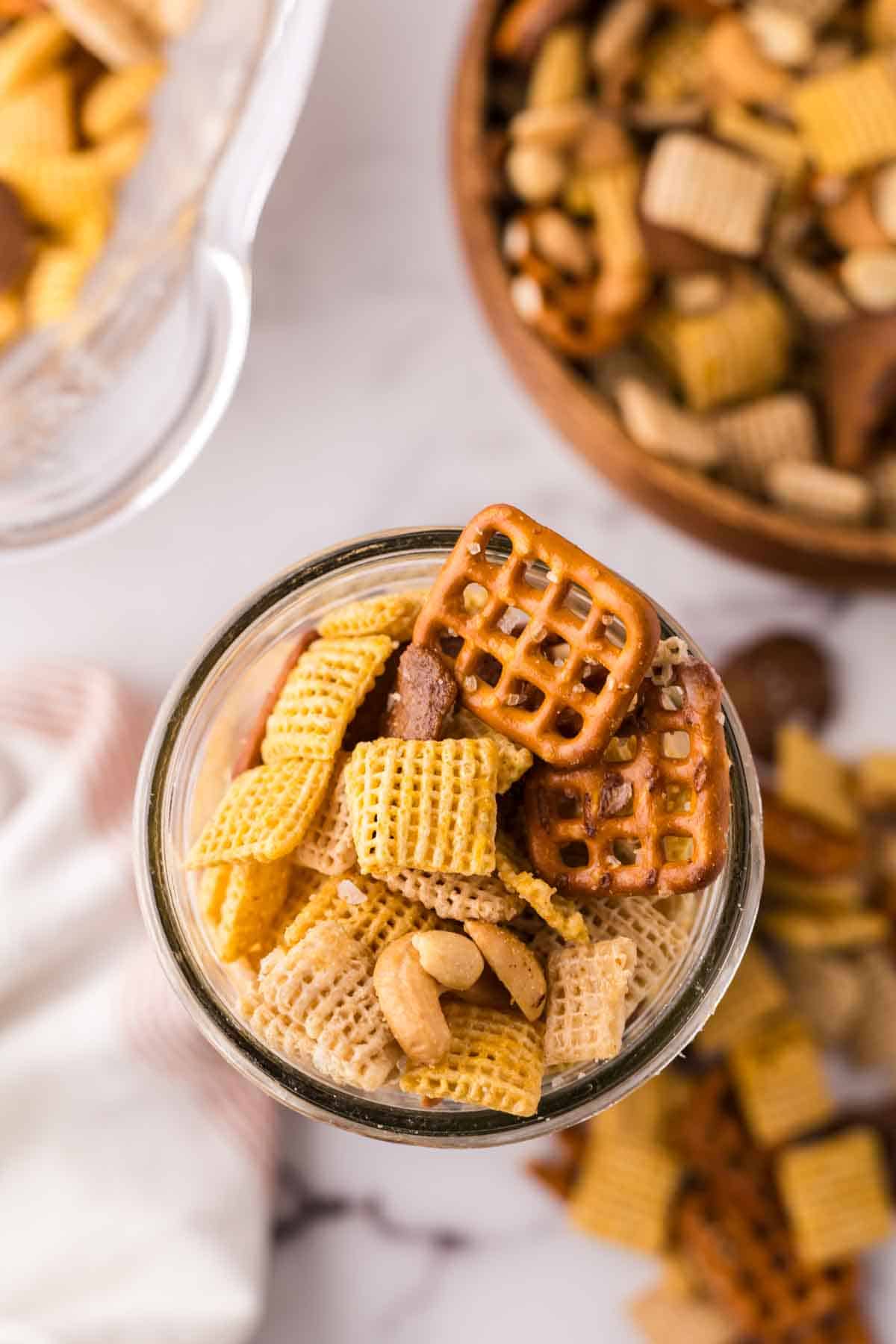 tall mason jar filled with chex mix recipe.