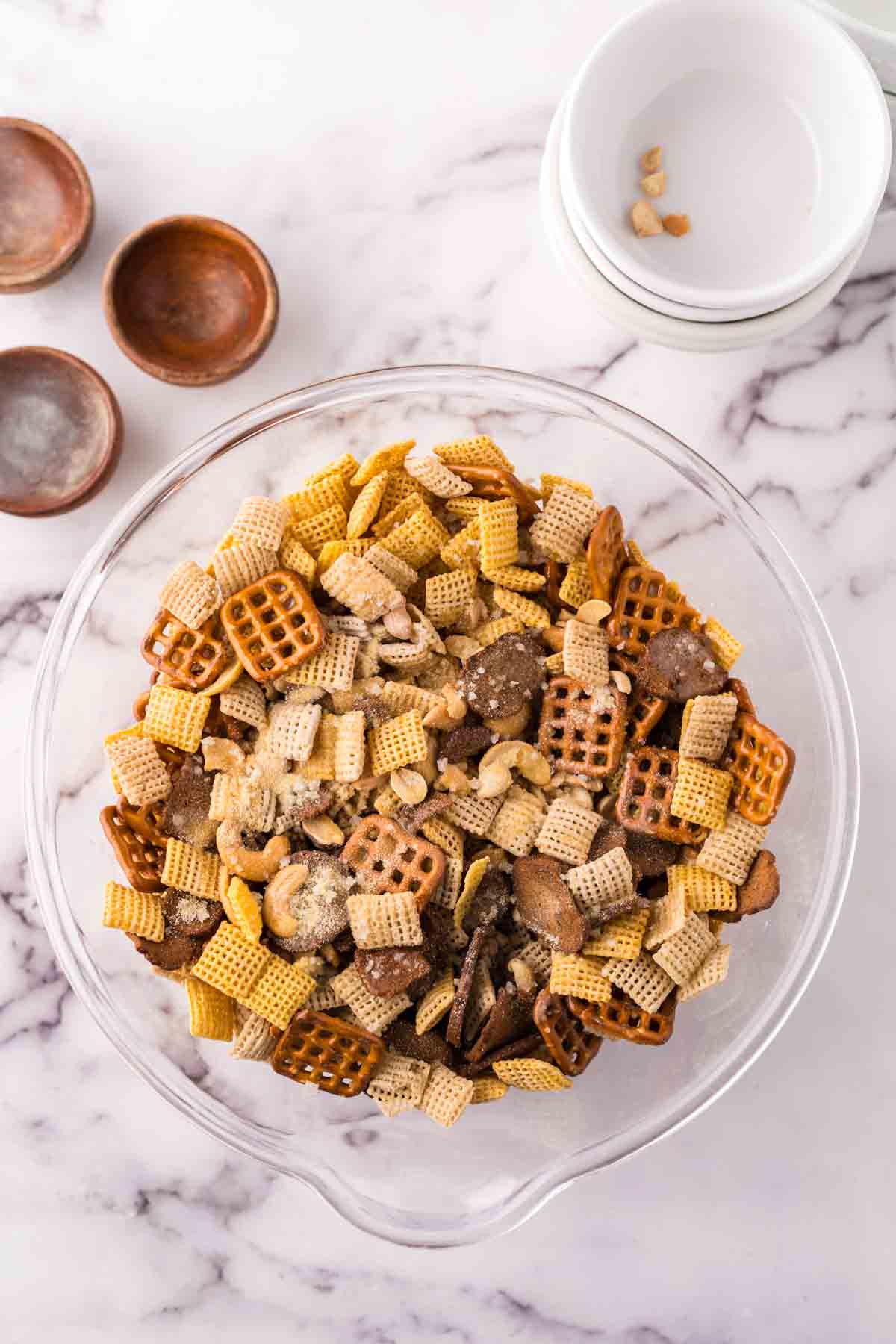 clear mixing bowl the progress of making chex mix recipe.