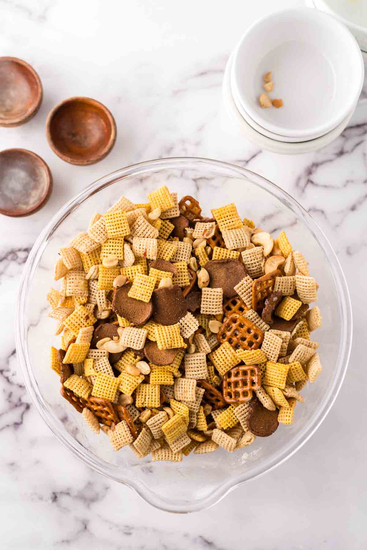 clear mixing bowl the progress of making chex mix recipe.