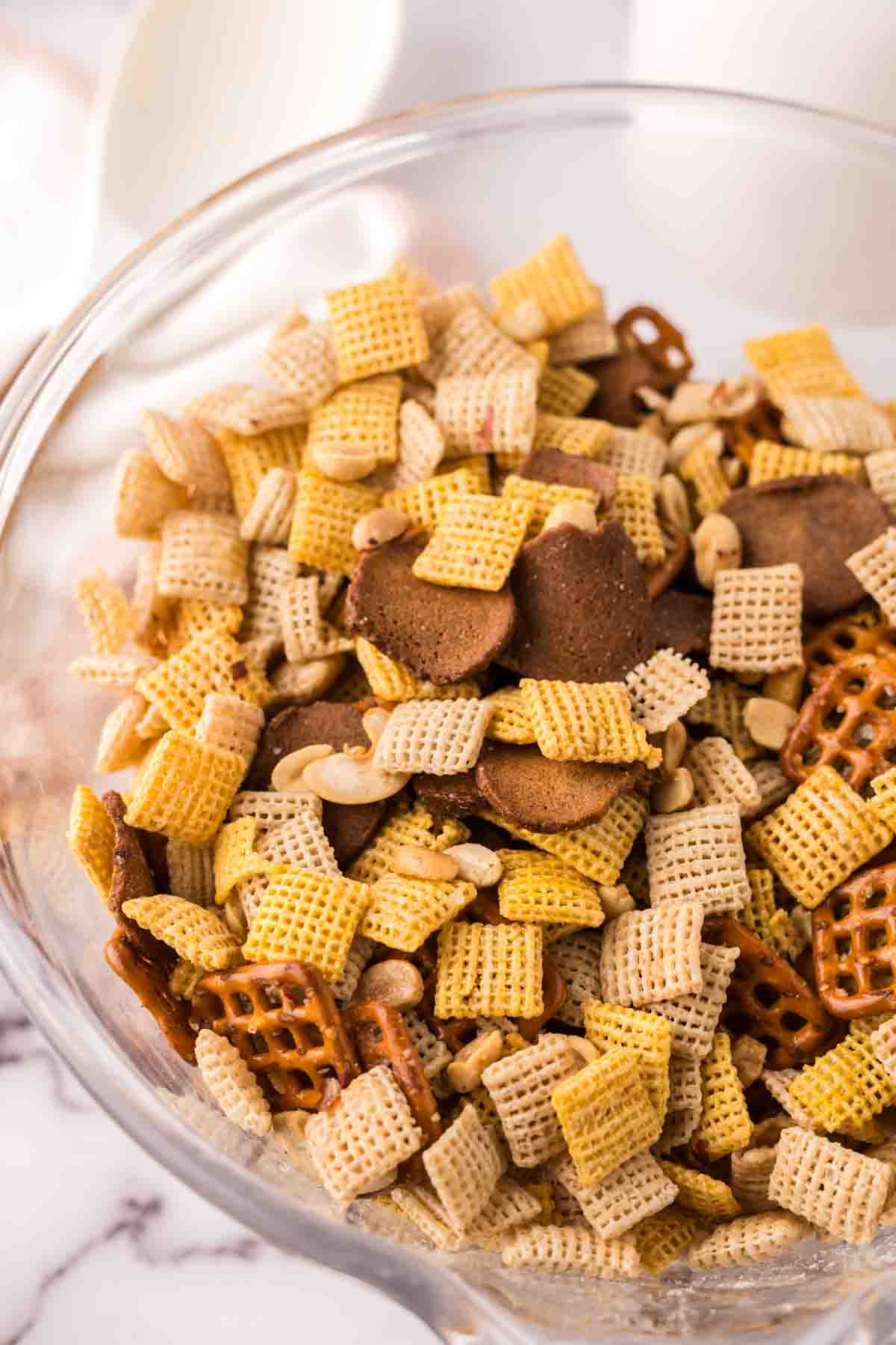 clear mixing bowl the progress of making chex mix recipe.