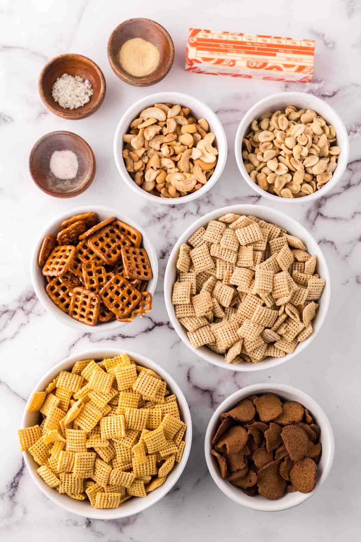 portion bowls each with raw ingredients to make chex mix recipe.