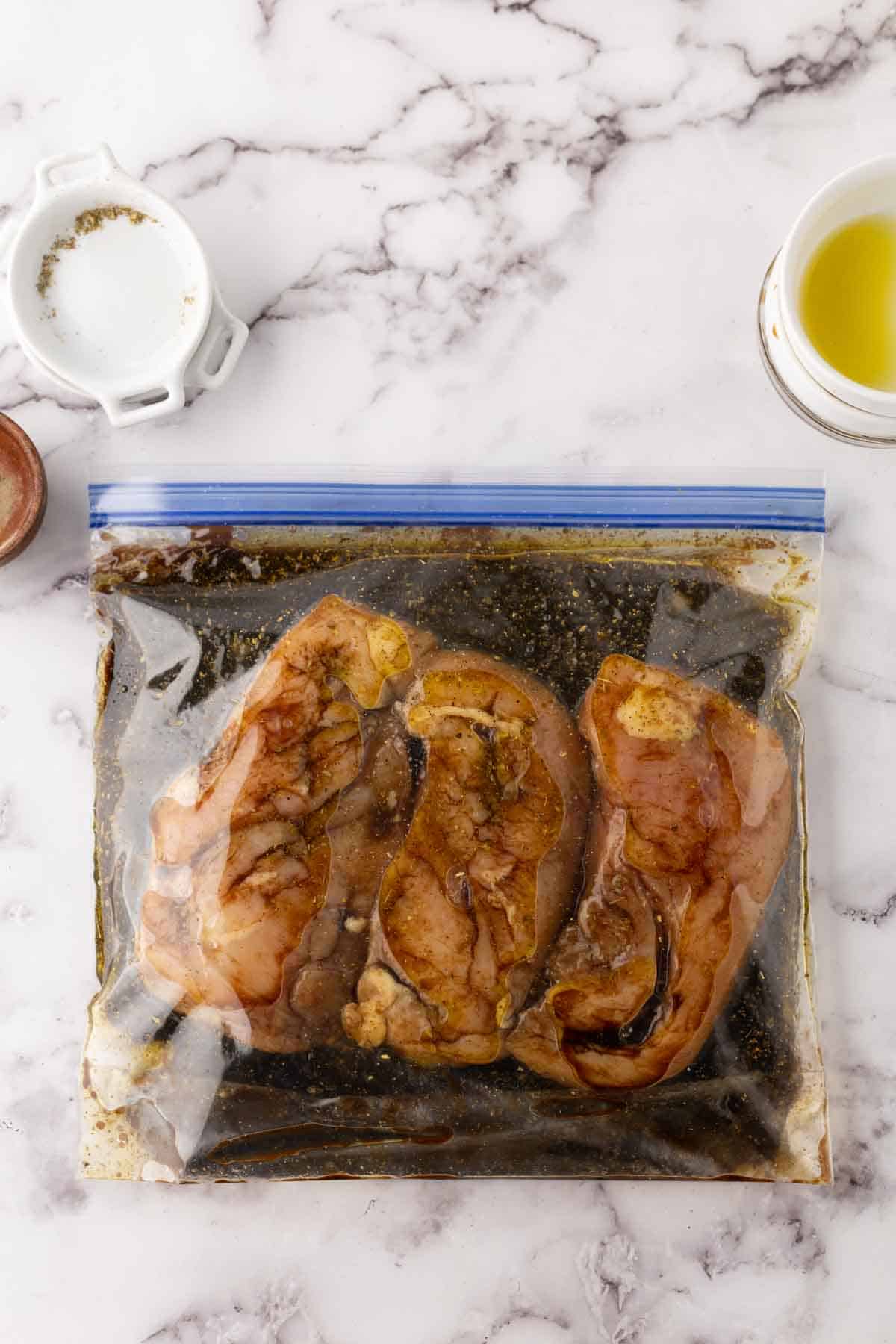 zip lock back with raw chicken breasts in homemade marinade.