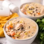white bowl with chicken wild rice recipe and a black spoon.