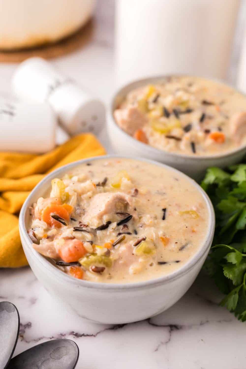 white bowl with chicken wild rice recipe and a black spoon.