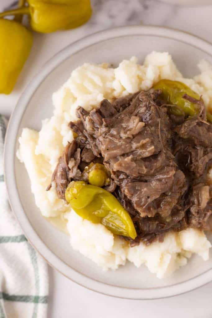 tender Mississippi shredded pot roast with pickled banana peppers over rice.