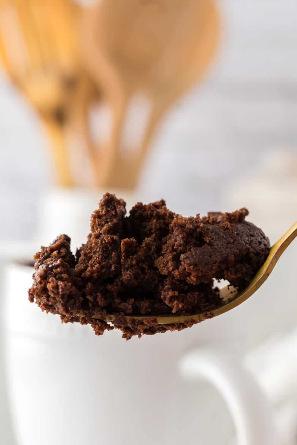 golden forkful of brown chocolate mug cake.