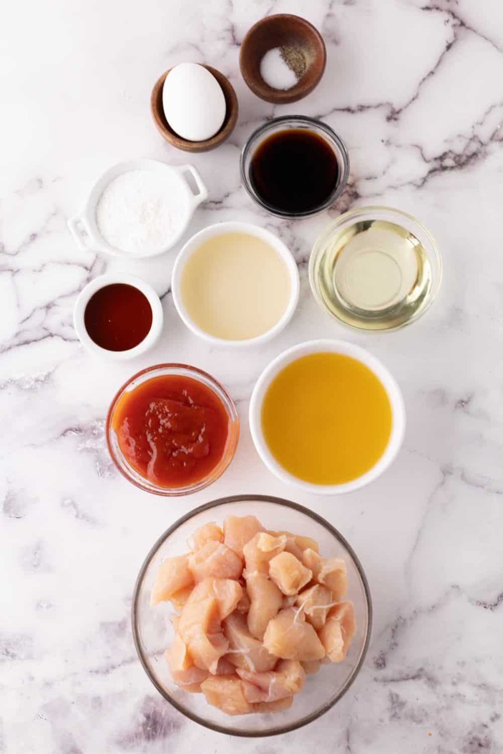 portion bowls each raw ingredient to make sweet and sour chicken recipe.