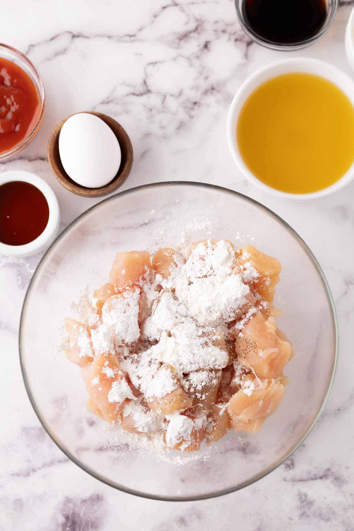 portion bowls each raw ingredient to make sweet and sour chicken recipe.