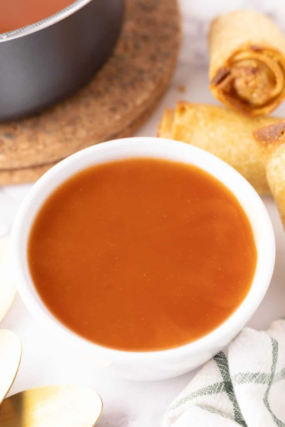 Finished sweet and sour sauce in a white round bowl. 