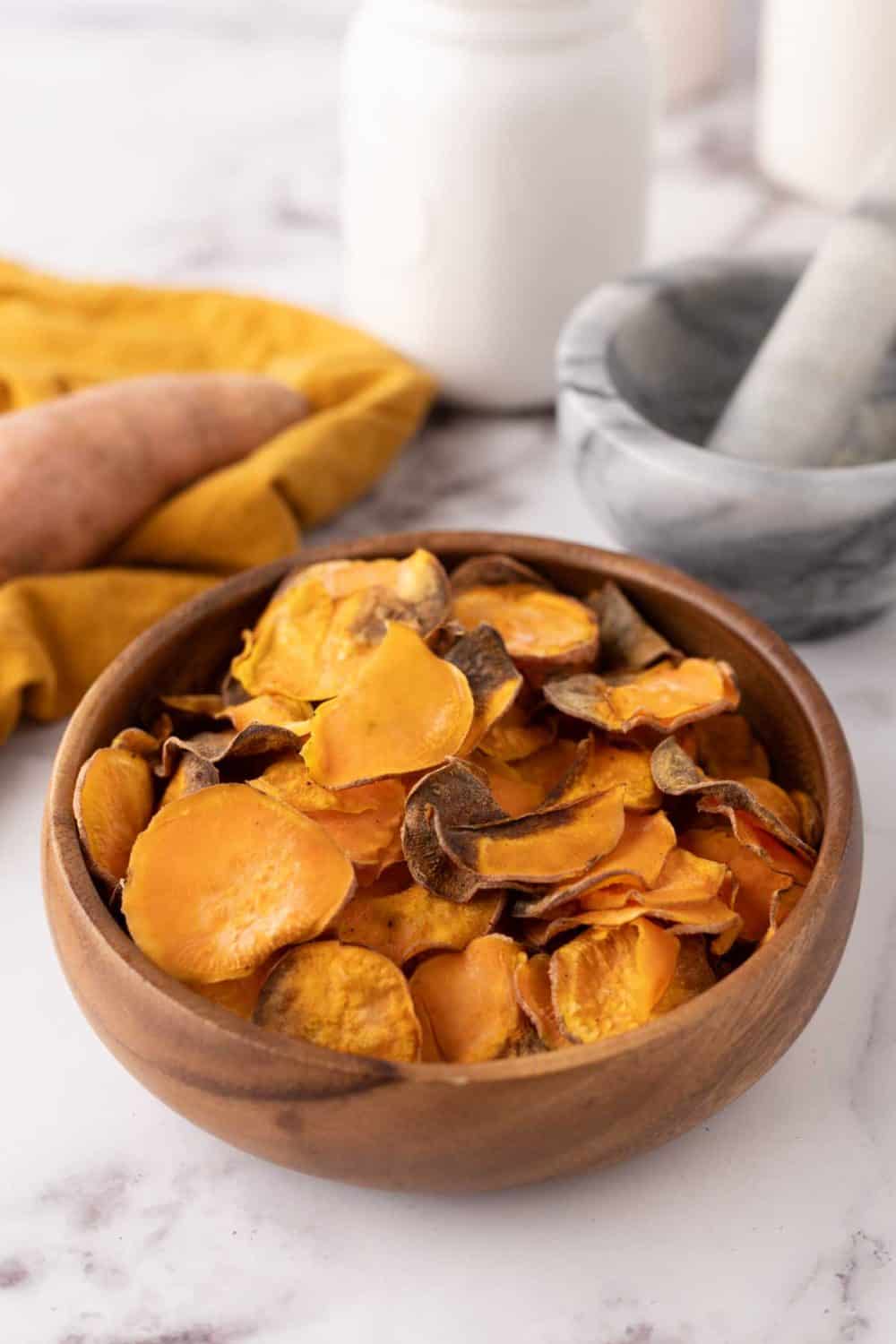 wooden bowl with air fried sweet potato chips.