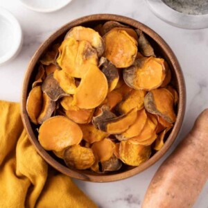 wooden bowl with air fried sweet potato chips.