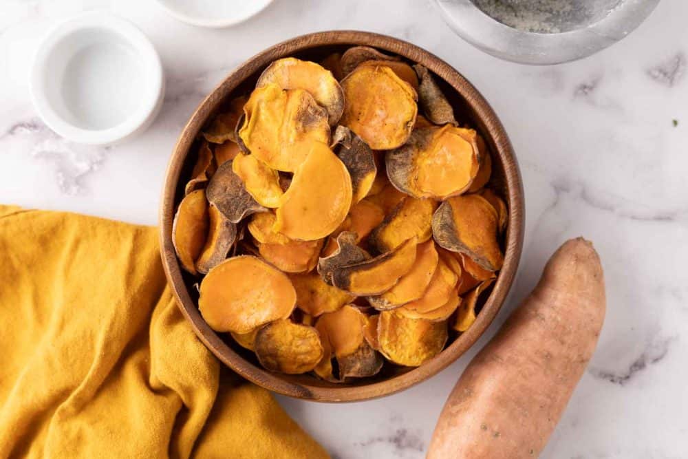wooden bowl with air fried sweet potato chips.
