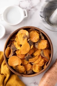 wooden bowl with air fried sweet potato chips.