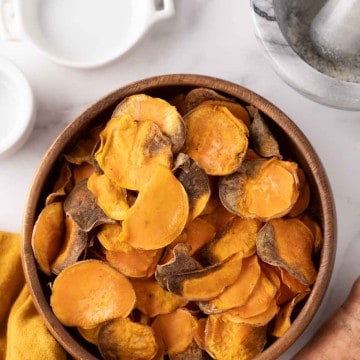 wooden bowl with air fried sweet potato chips.