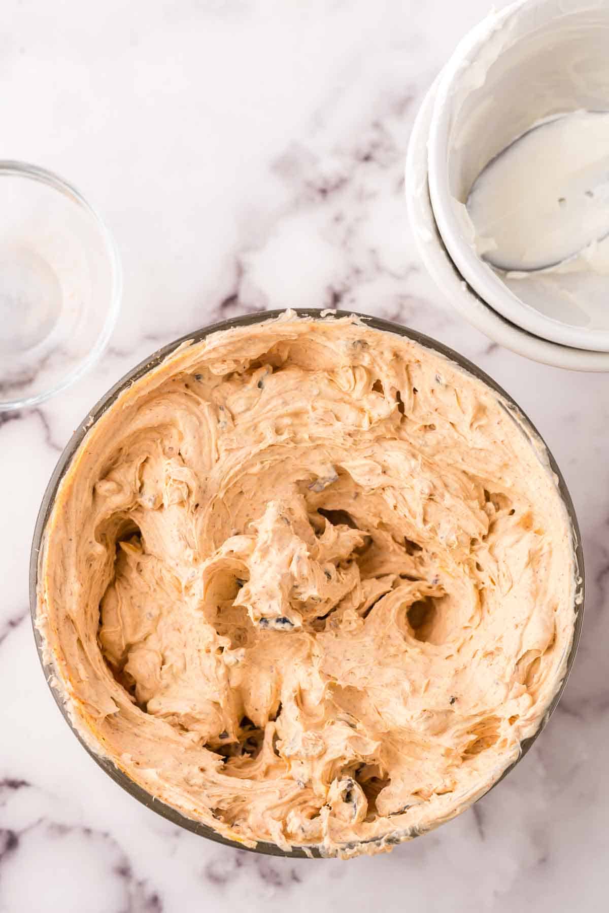 clear mixing bowl with whipped Taco Dip.