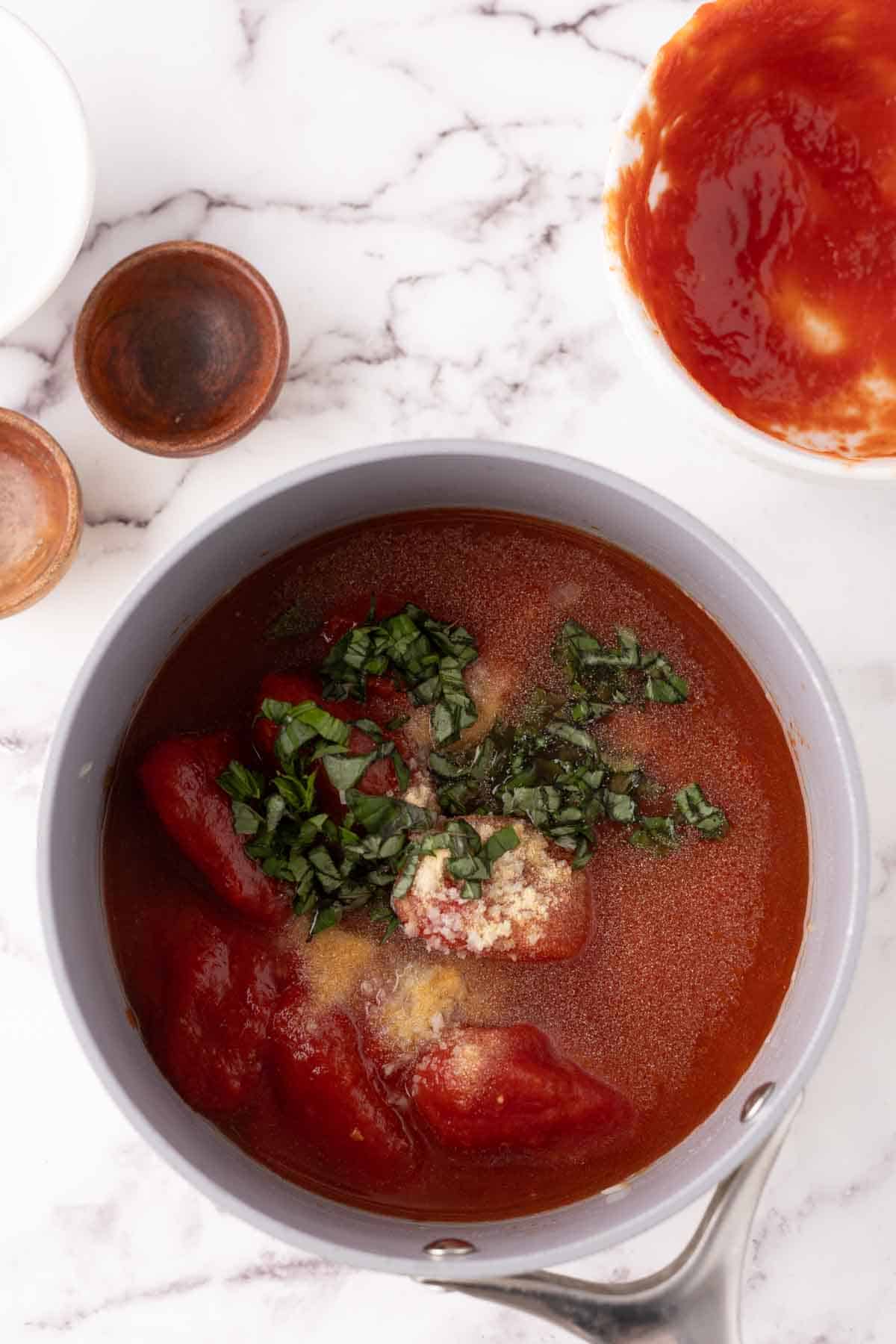 pot of cooking tomato basil soup in progress.