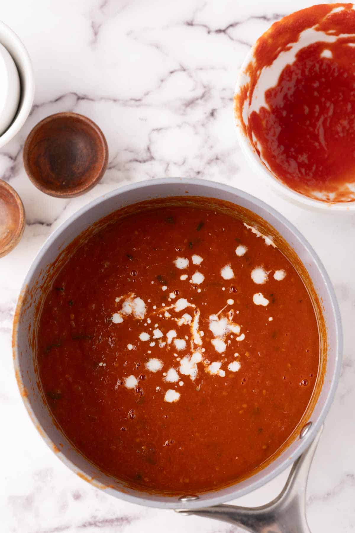 pot of cooking tomato basil soup in progress.