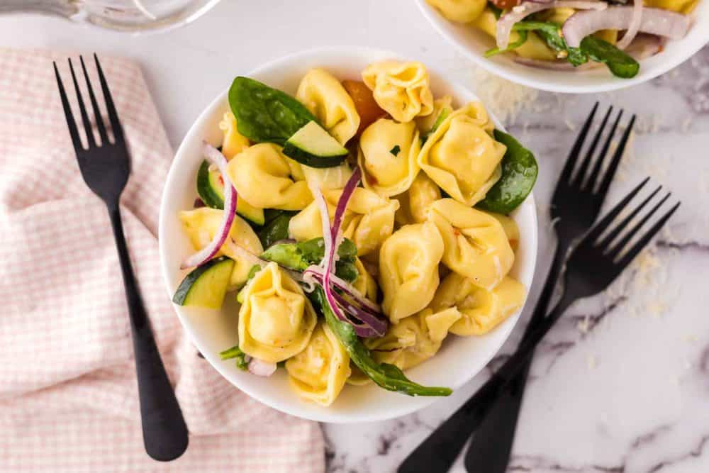 tortellini salad in a round white bowl.