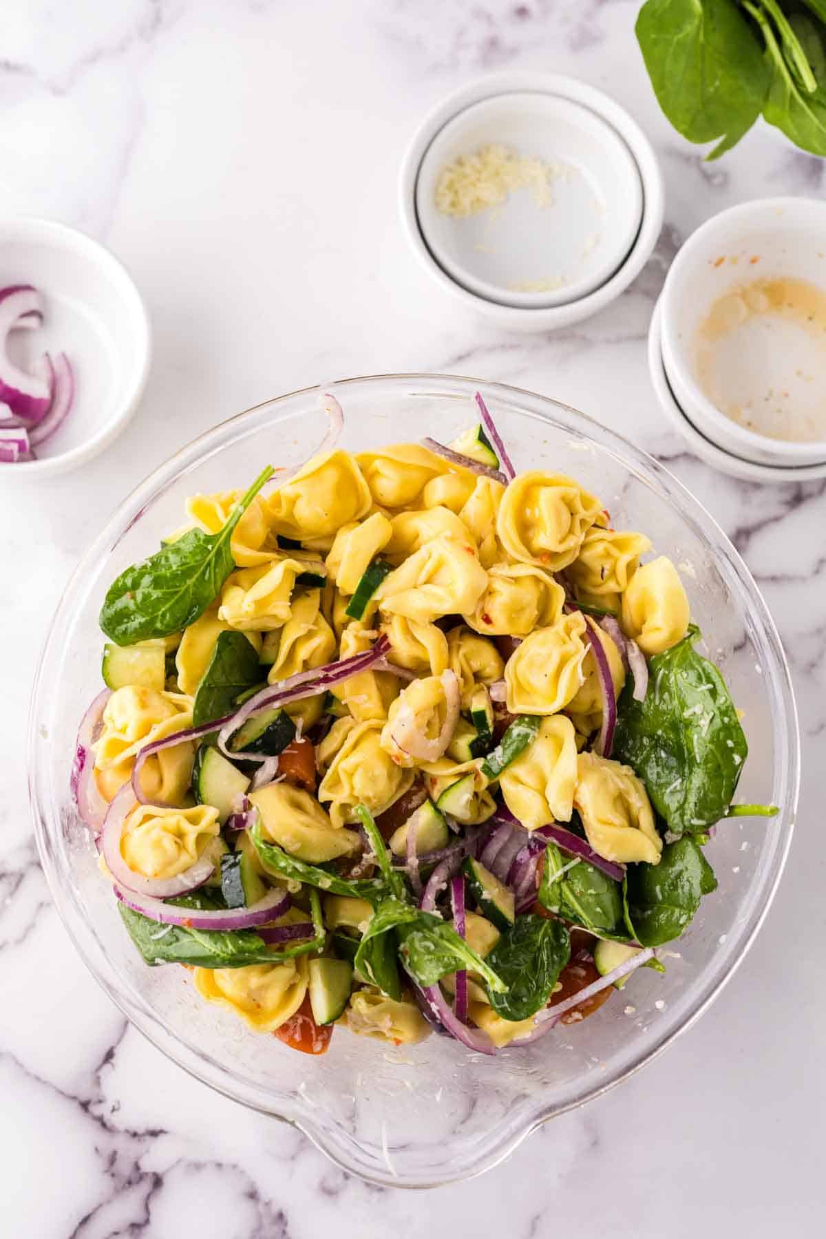 mixing bowl of tortellini salad.