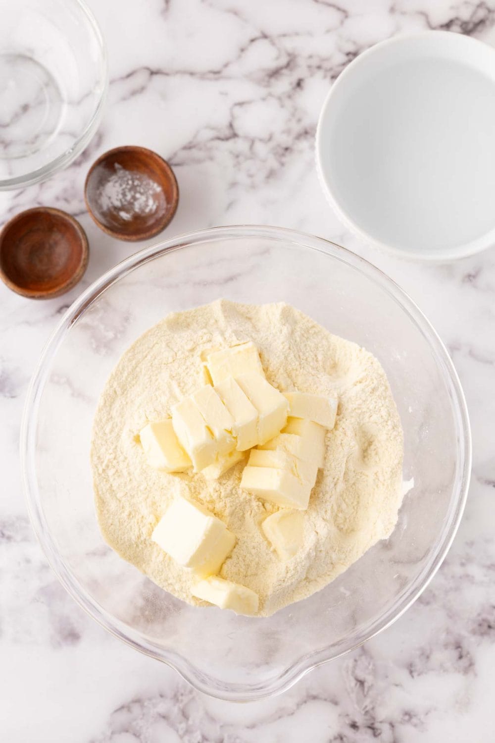 tortilla dough in a clear mixing bowl in progress.