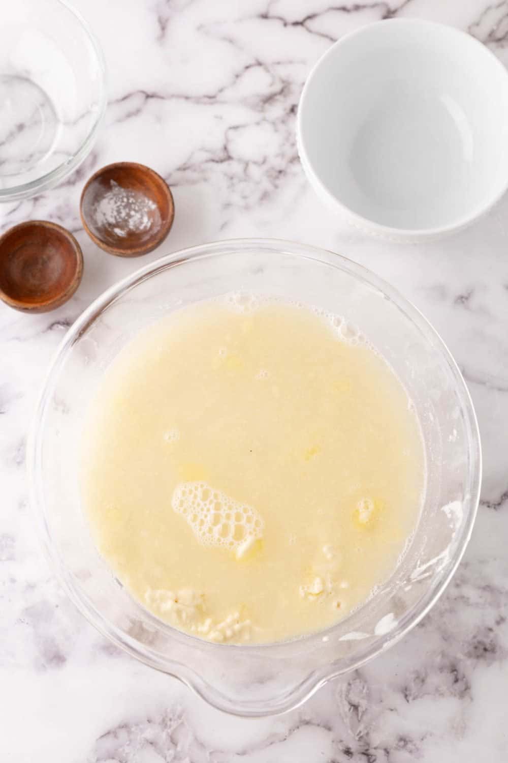 tortilla dough in a clear mixing bowl in progress.