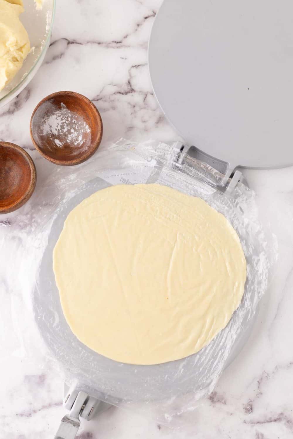 tortilla dough in a press before cooking.