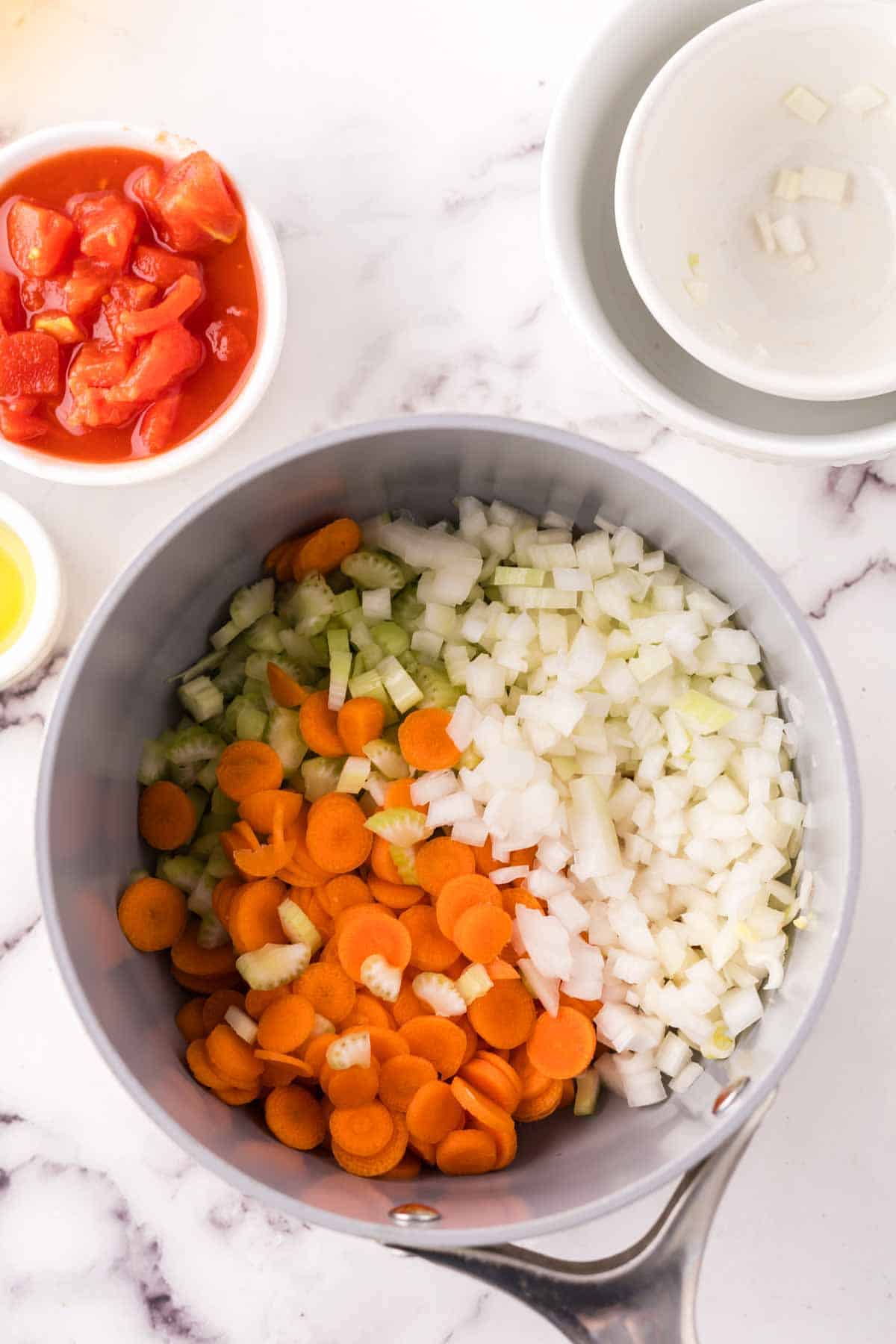 Sautéing vegetables in a pot for vegetable soup. 