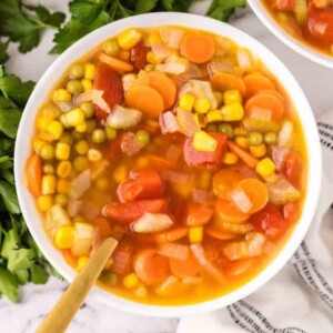 Vegetable soup served in a white bowl.