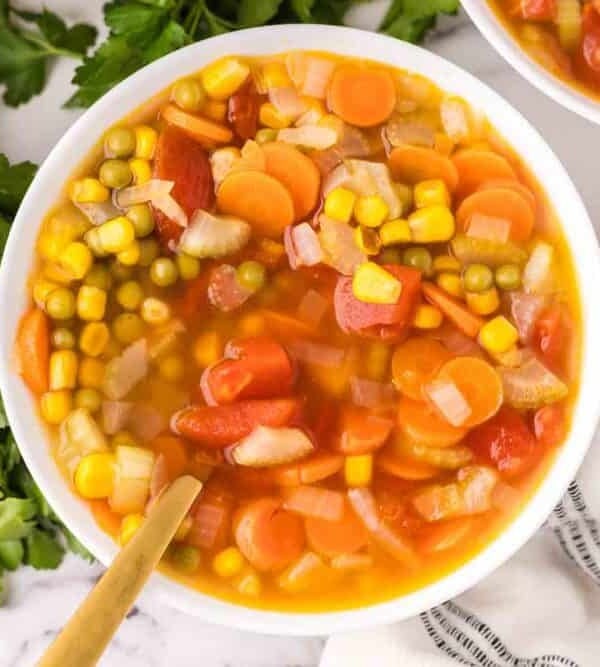 Vegetable soup served in a white bowl.