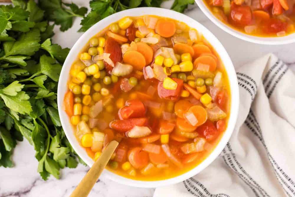 Vegetable soup served in a white bowl.