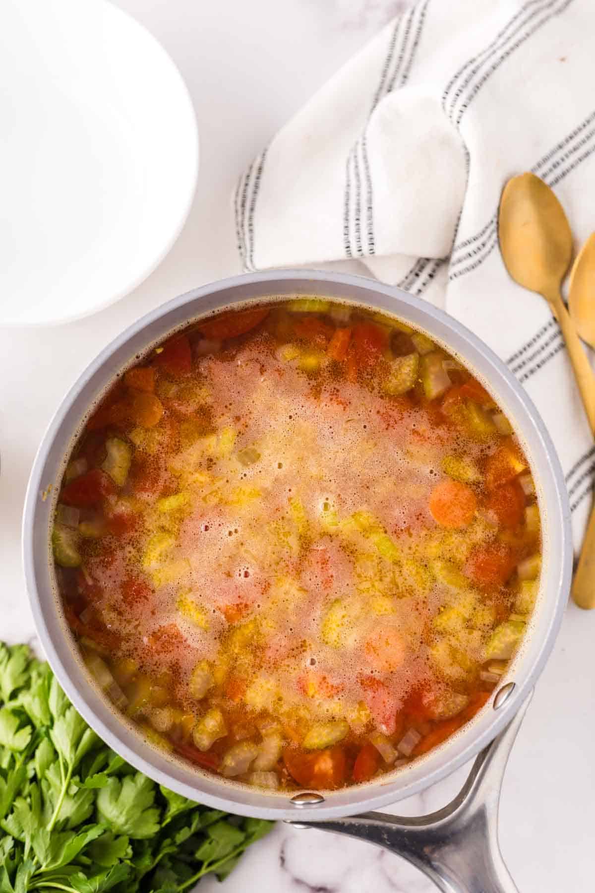 Pot of vegetable soup simmering. 