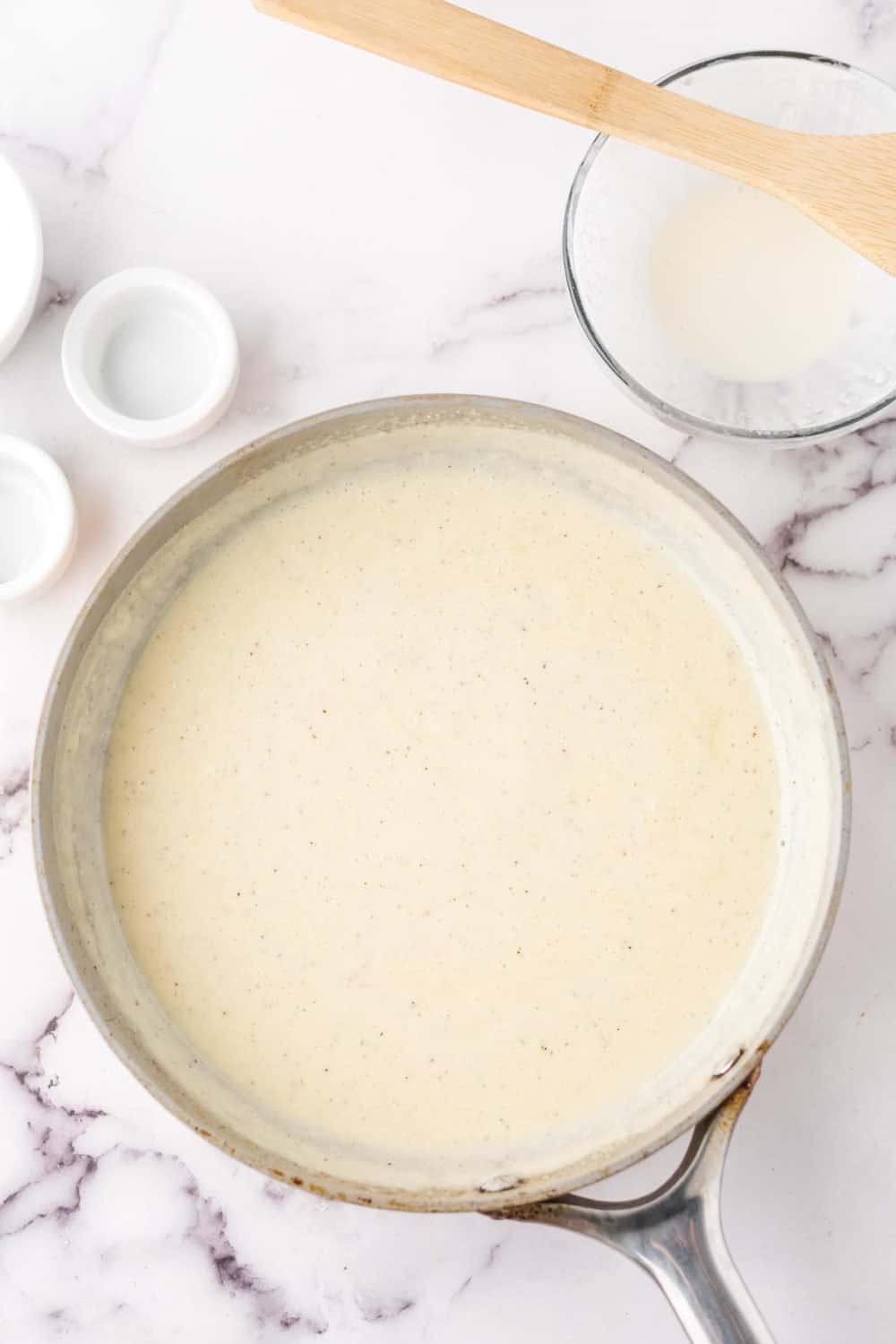 sauce pan with smooth and creamy white pizza sauce recipe.