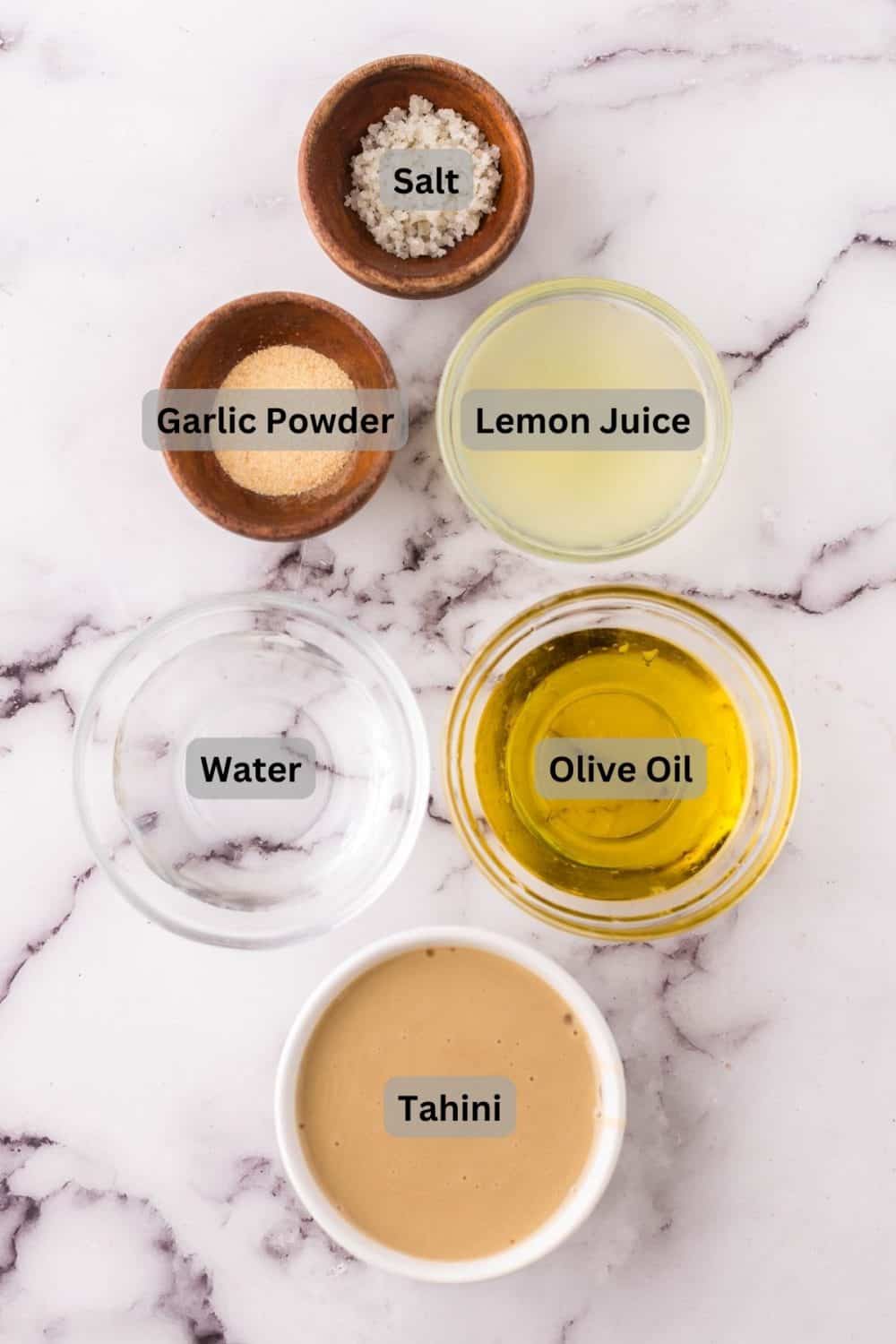 portion bowls with digital labels for each raw ingredient to make tahini dressing.