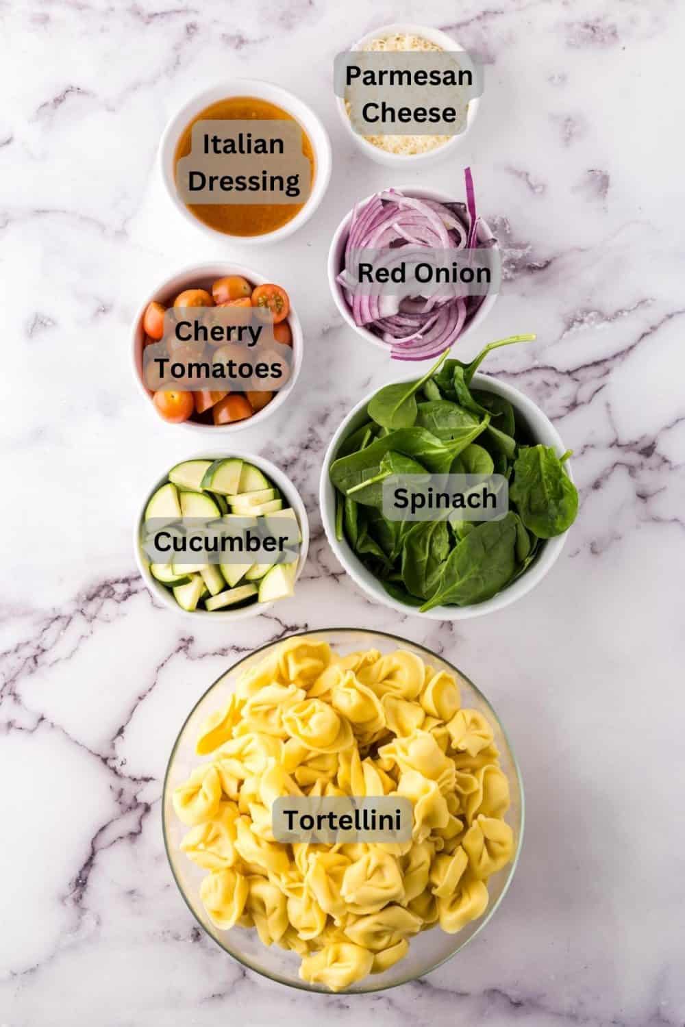portion bowls with digital labels for each raw ingredient to make tortellini salad.