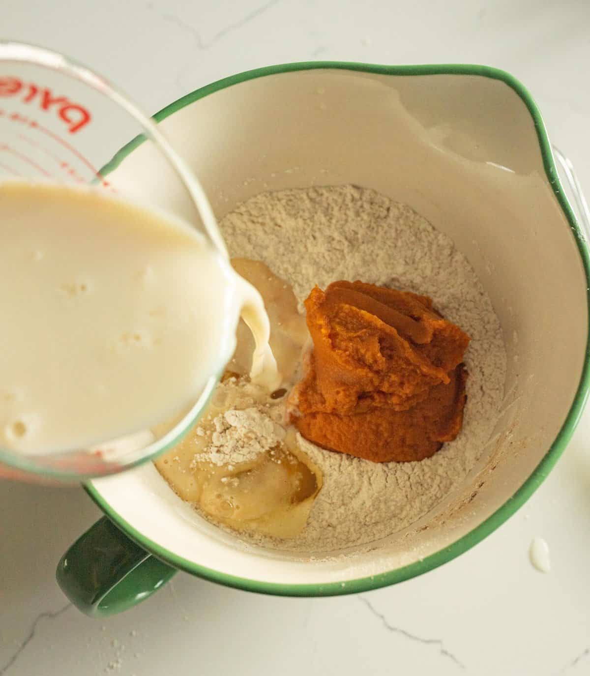 fluffy pumpkin pancakes wet ingredients being poured into the dry ingredients.