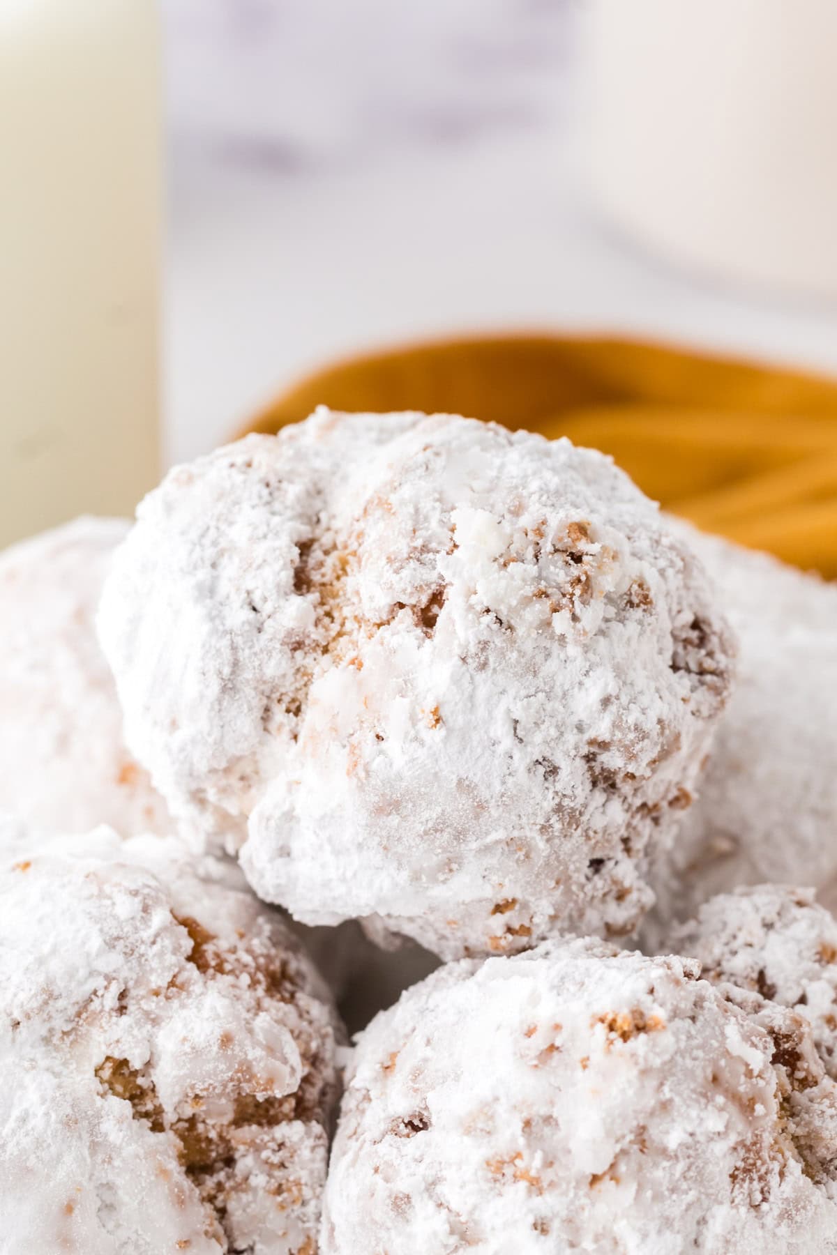 Up close view of a white powdered donut.