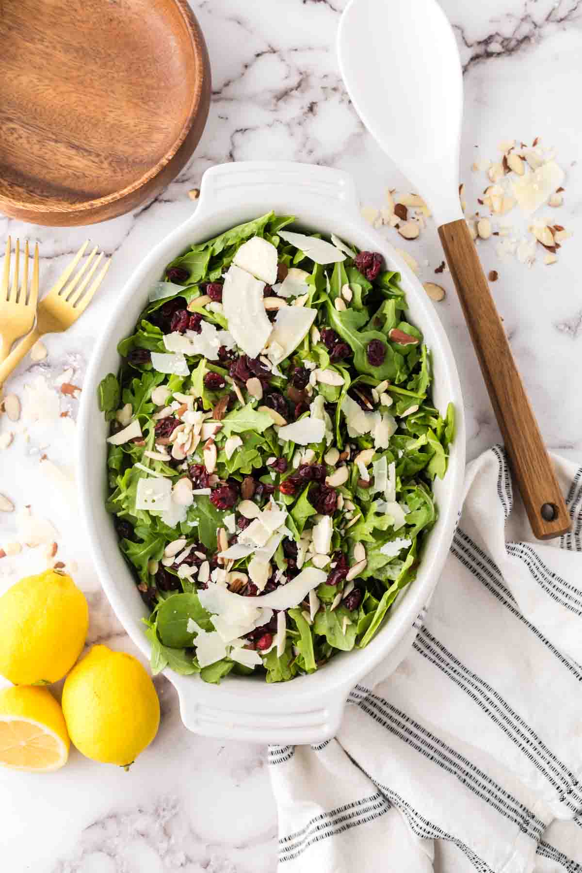 arugula salad recipe in a white oval serving dish.